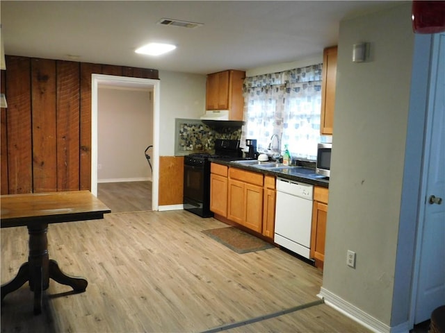 kitchen with black electric range, white dishwasher, light hardwood / wood-style flooring, and sink