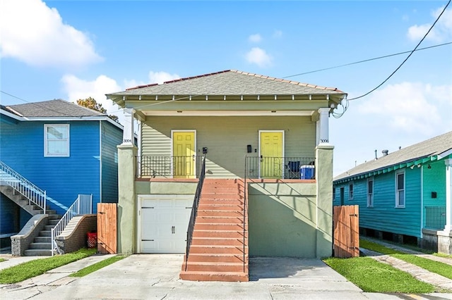 bungalow with a porch and a garage