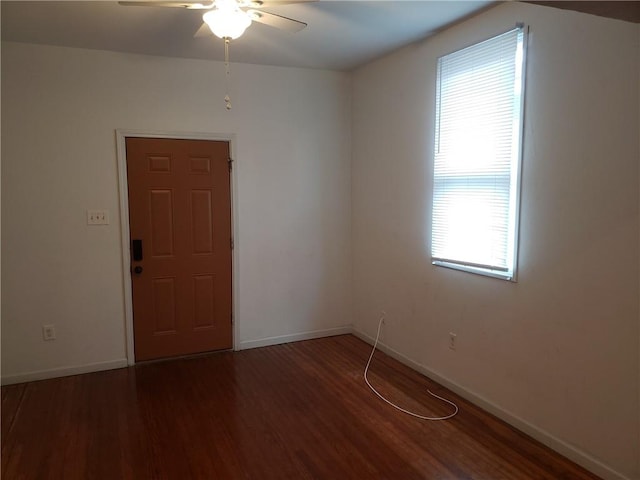 unfurnished room featuring ceiling fan and dark hardwood / wood-style floors