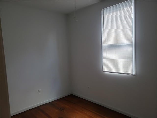 empty room with dark hardwood / wood-style floors