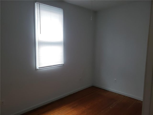 unfurnished room with hardwood / wood-style flooring