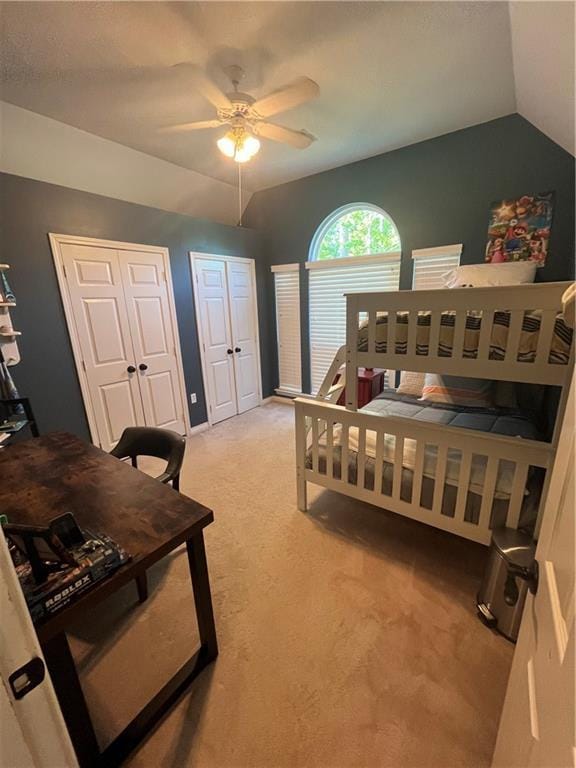 bedroom featuring ceiling fan, light carpet, and vaulted ceiling