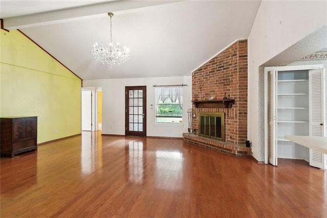 unfurnished living room with a chandelier, hardwood / wood-style floors, vaulted ceiling with beams, and a brick fireplace