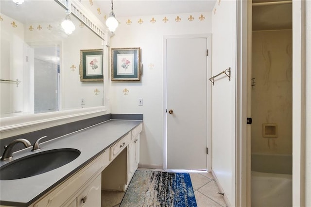 bathroom with tile patterned flooring, a shower, and vanity