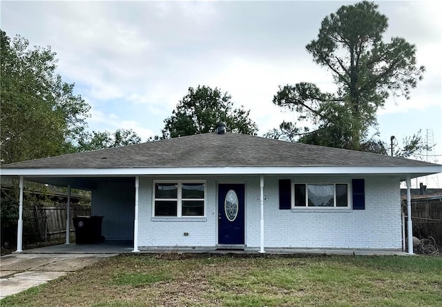 single story home featuring a front yard and a carport