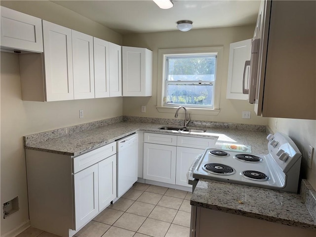 kitchen with white cabinets, light stone counters, white appliances, and sink