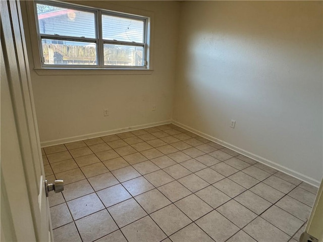 spare room featuring light tile patterned flooring