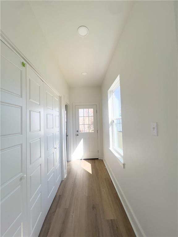 hallway with hardwood / wood-style flooring