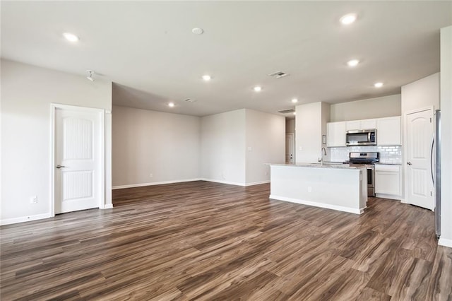 unfurnished living room with dark wood-type flooring and sink