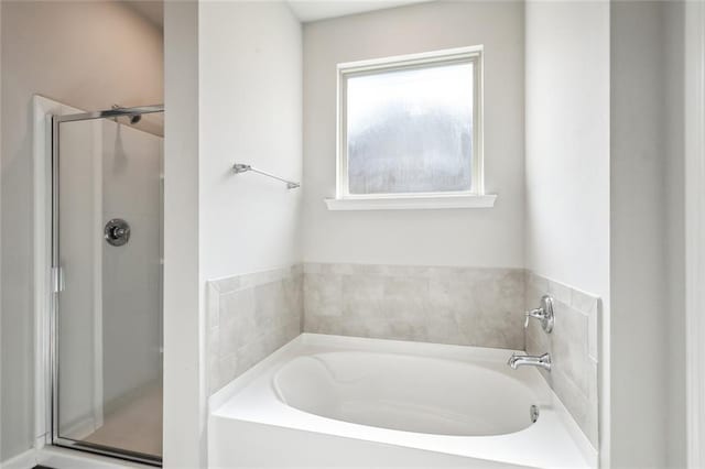 bathroom featuring separate shower and tub