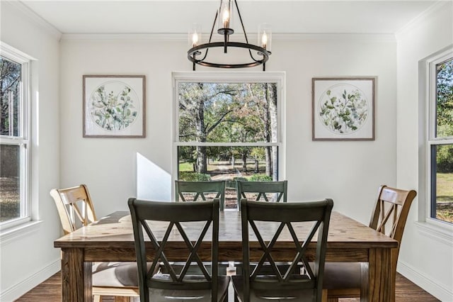 dining room with a notable chandelier, dark hardwood / wood-style floors, and ornamental molding