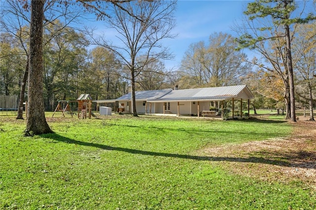 view of yard with a trampoline and a playground