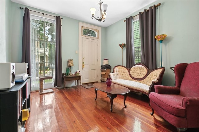 sitting room featuring hardwood / wood-style floors and a notable chandelier