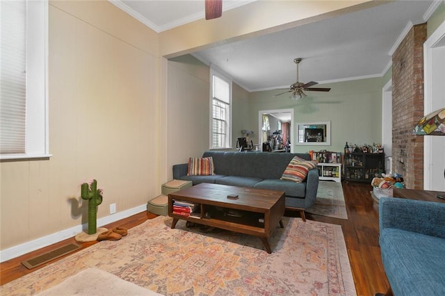 living room featuring ceiling fan, dark hardwood / wood-style floors, and ornamental molding