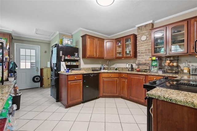 kitchen with light stone counters, ornamental molding, sink, black appliances, and light tile patterned floors