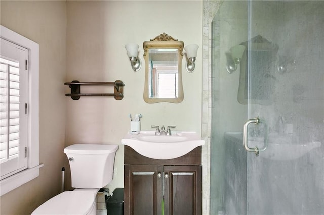 bathroom with an enclosed shower, vanity, and plenty of natural light