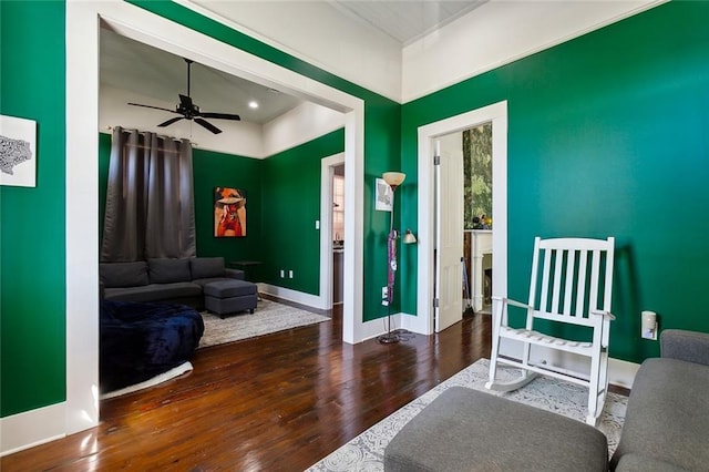 sitting room featuring dark hardwood / wood-style floors and ceiling fan