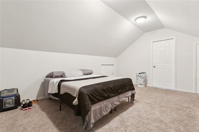 bedroom featuring carpet floors and vaulted ceiling