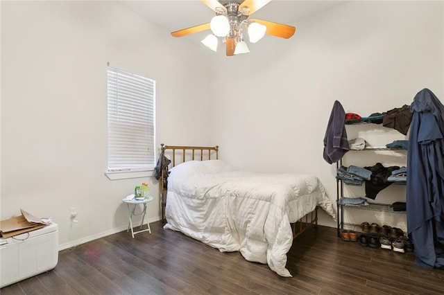 bedroom with ceiling fan and dark hardwood / wood-style floors