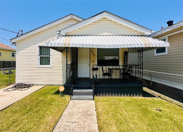 bungalow-style house with a front lawn and a porch