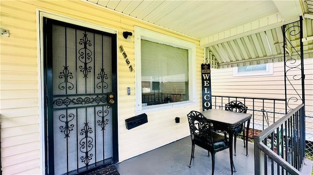 doorway to property featuring covered porch