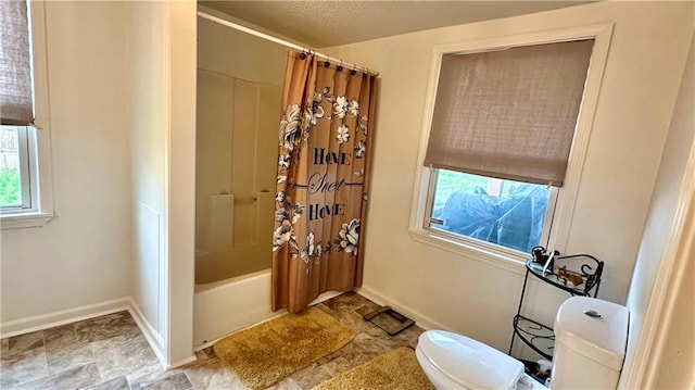 bathroom featuring toilet and shower / bathtub combination with curtain