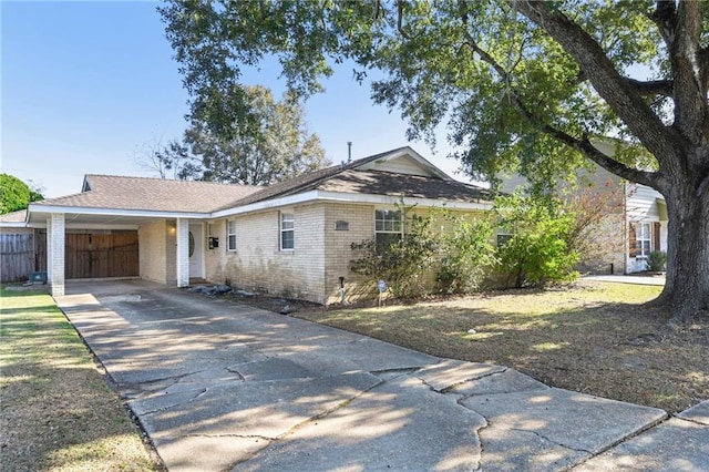 ranch-style home featuring a carport