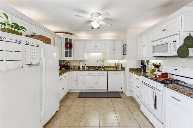 kitchen with white cabinets, white appliances, dark stone counters, and sink