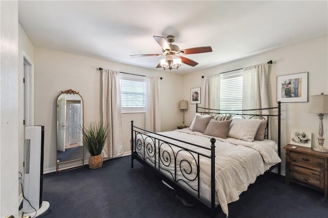 bedroom featuring dark colored carpet and ceiling fan