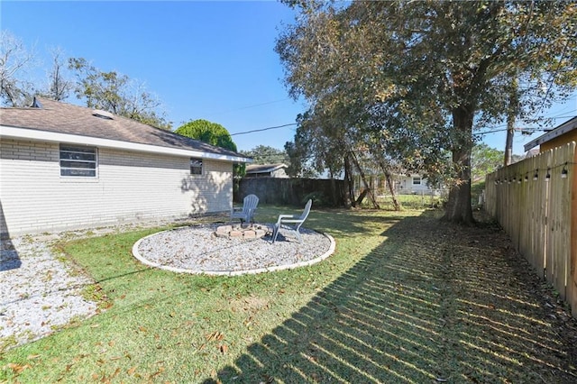 view of yard featuring an outdoor fire pit