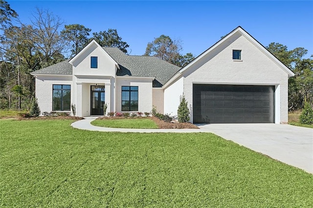 modern inspired farmhouse featuring a garage and a front yard