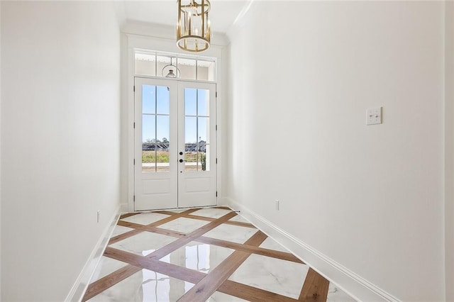 entryway with a chandelier and french doors