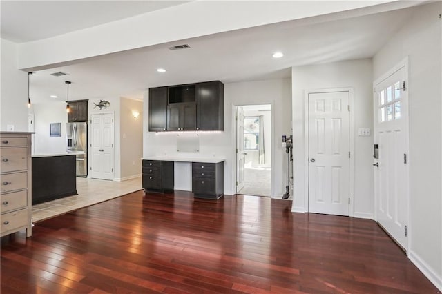 unfurnished living room with dark wood-type flooring