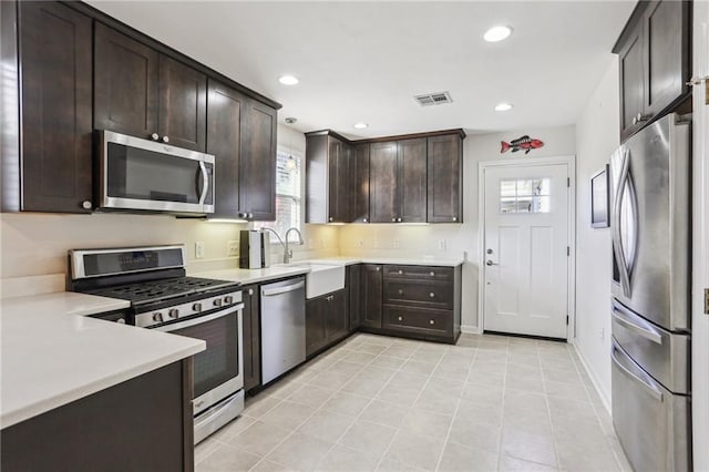 kitchen with dark brown cabinets, sink, plenty of natural light, and appliances with stainless steel finishes