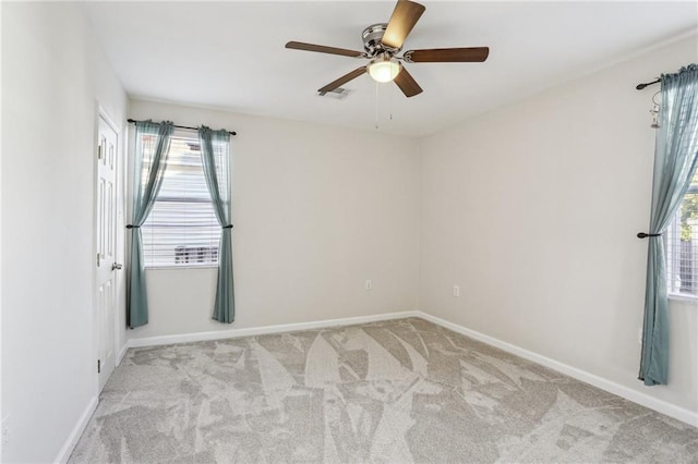 carpeted empty room featuring ceiling fan