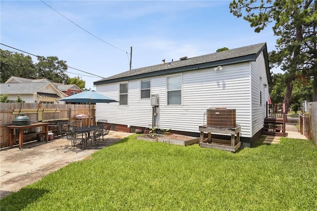 back of house featuring a lawn and a patio