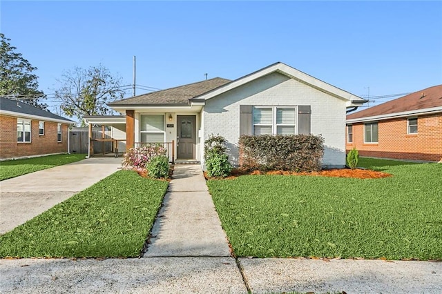 bungalow-style house with a front yard and a carport