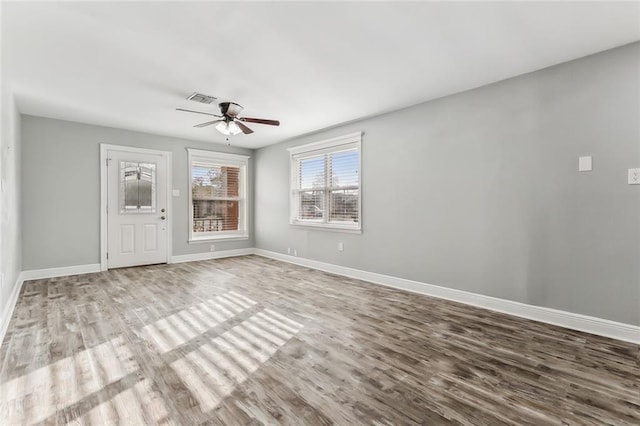 empty room with ceiling fan and hardwood / wood-style flooring