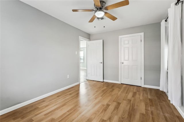 unfurnished bedroom featuring ceiling fan and light wood-type flooring