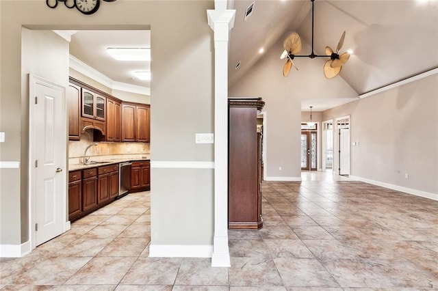 kitchen with ornate columns, ceiling fan, stainless steel dishwasher, vaulted ceiling, and decorative backsplash