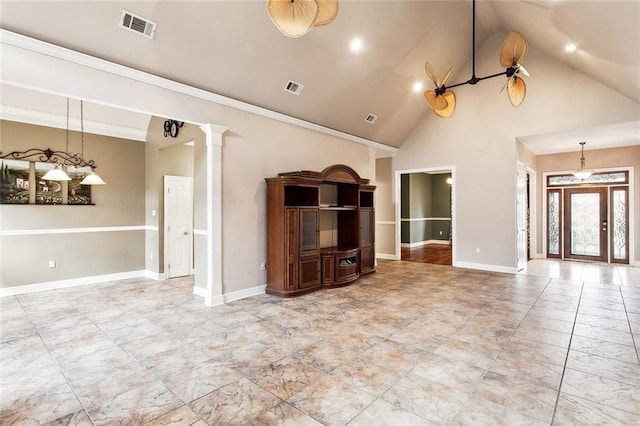 unfurnished living room with ornamental molding, high vaulted ceiling, and decorative columns