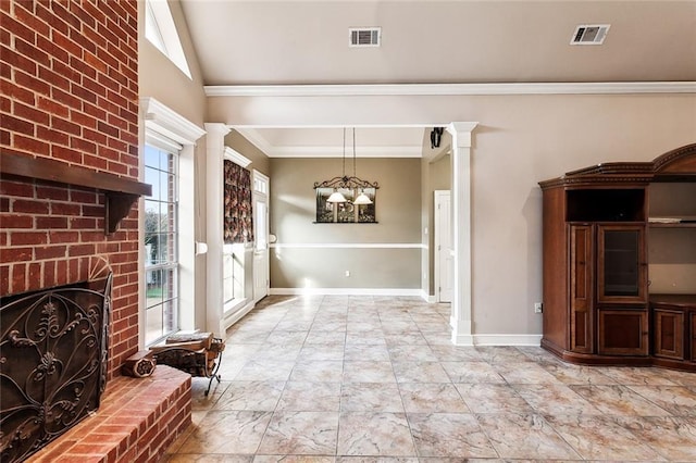 unfurnished dining area with a brick fireplace, crown molding, and an inviting chandelier