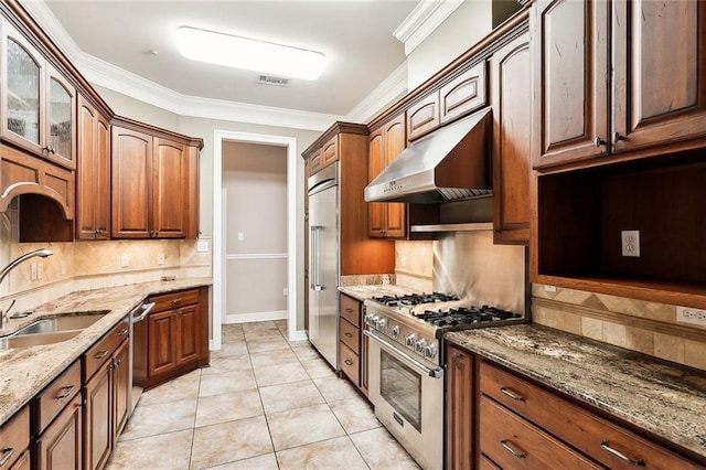 kitchen featuring light stone counters, high end appliances, ornamental molding, and light tile patterned flooring