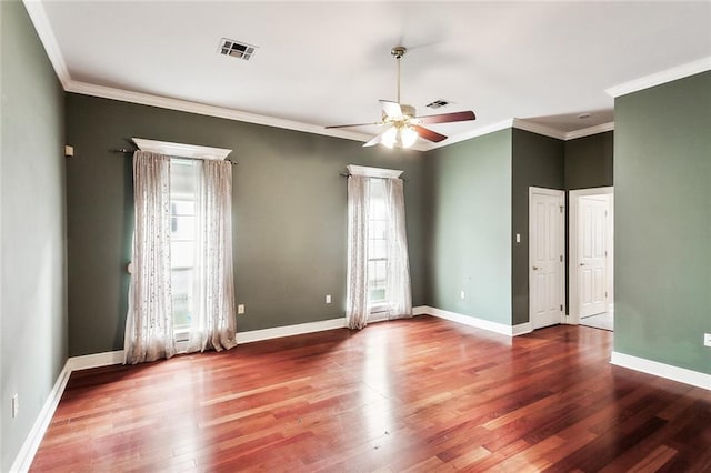 empty room with hardwood / wood-style floors, ceiling fan, and crown molding