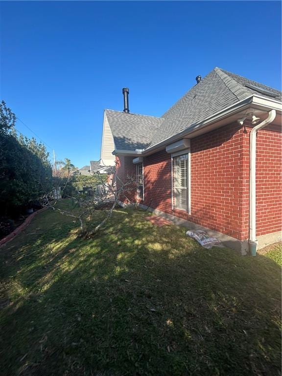 view of side of home featuring a lawn