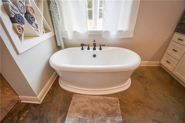 bathroom featuring vanity and a bath