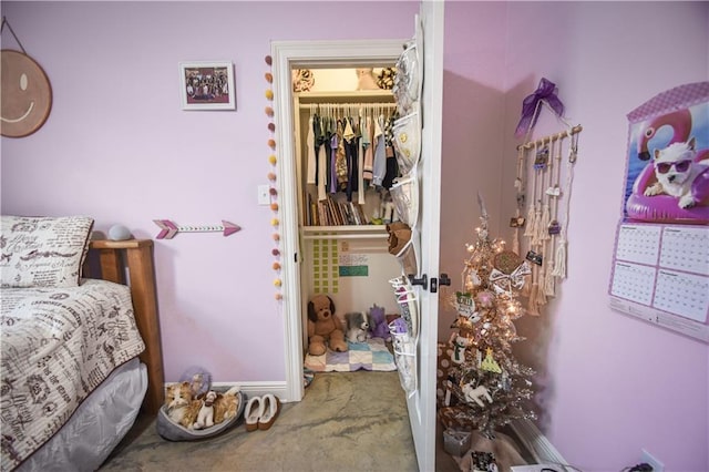 bedroom featuring a spacious closet, carpet floors, and a closet