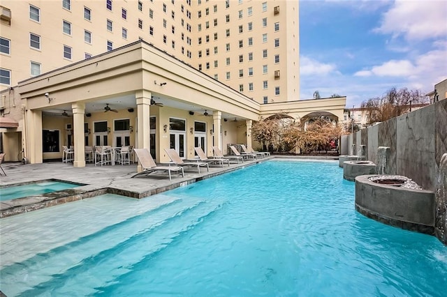 community pool with a patio area, an in ground hot tub, ceiling fan, and fence