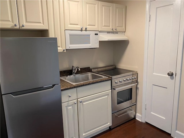 kitchen with stainless steel appliances, a sink, white cabinets, and under cabinet range hood