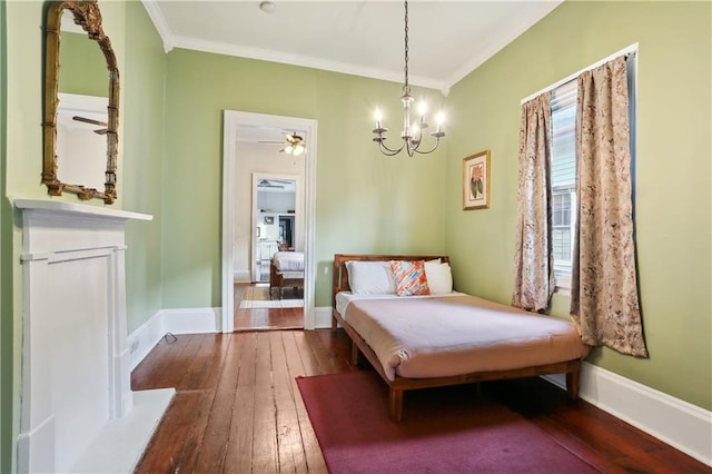 bedroom with hardwood / wood-style flooring, crown molding, and an inviting chandelier